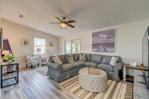 a living room with a couch and a ceiling fan at Peaceful Lady Lake Home with Screened-In Porch! in Lady Lake