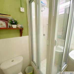 a bathroom with a toilet and a glass shower at Seacastle Deluxe Studio in Montego Bay +56 photos