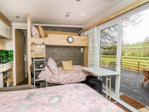 a bedroom with a bunk bed and a balcony at The Fox Den in Rhayader