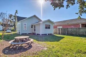 a picnic table in front of a house at Lake Charles Cottage with Fireplace and Yard! in Lake Charles