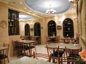 a restaurant with tables and chairs in a room at Luxor Hotel Hurghada in Hurghada