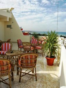 a group of chairs and tables on a patio at Luxor Hotel Hurghada in Hurghada