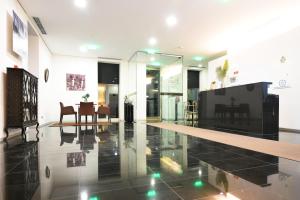 a living room with a table and a dining room at Lazza Hotel in Figueira da Foz