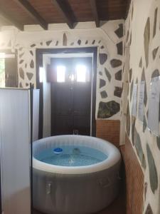 a large bath tub in a bathroom with a shower at Casita Rural con Jacuzzi climatizado. in Los Realejos