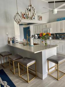 a kitchen with a large counter with stools in it at Punta Gorda Isles Haven in Punta Gorda