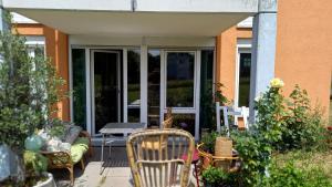 un patio avec des chaises et une table en face d'un bâtiment dans l'établissement Grüne Stadtwohnung, à Sarrebruck