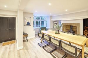 a dining room with a table and chairs and a fireplace at Host & Stay- Graham House in Osmotherley