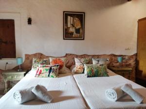 a bedroom with two beds with towels on them at Can Pep Pardal in Sant Miquel de Balansat +36 photos