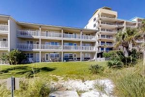 a large apartment building with a lawn in front of it at Summer Breeze 21 in Orange Beach