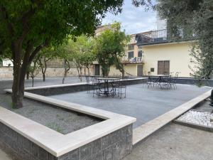 a courtyard with tables and chairs and a building at B&B Villa Filù in Portici