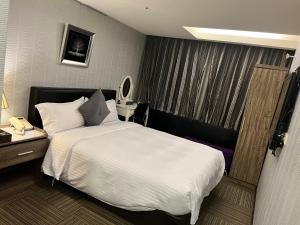En eller flere senger på et rom på 意芙旅店 Ifinn Hotel