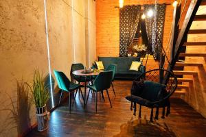 a patio with a table and chairs and a couch at Apartament Piorun in Mrągowo