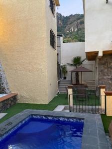 ein Swimmingpool im Garten eines Hauses mit Terrasse in der Unterkunft Villa Chica in Tepoztlán