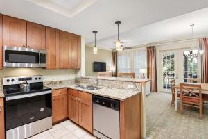 a kitchen with wooden cabinets and a dining room at Royal Dunes in Hilton Head Island