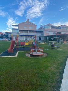 a playground in front of a building at Apartment Privlaka direkt am Strand mit Klima und neuem Badezimmer Haustiere sind willkommen in Privlaka