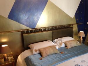 a bed with two pillows on top of it at Glan Llyn Farm House in Mold +32 photos