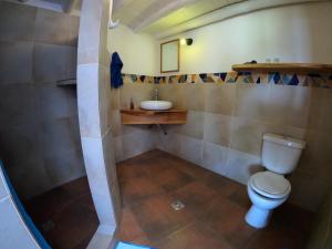 a bathroom with a toilet and a sink at Hotel La Cupula in Copacabana