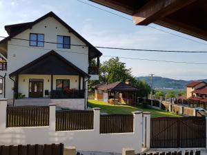 a white house with a black roof at Casa Aryana, adults only in Bran