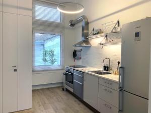 a kitchen with a sink and a refrigerator at CoCo Romantic - apartment in most trendy central hotspot of Antwerp in Antwerp