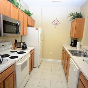 a kitchen with a white refrigerator and a sink at Condominium Apartment Close to Disney in Orlando Florida in Orlando