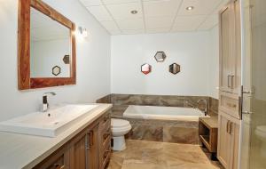 a bathroom with a sink and a tub and a toilet at 76.5 Chemin de la Perdrix in Stoneham +30 photos