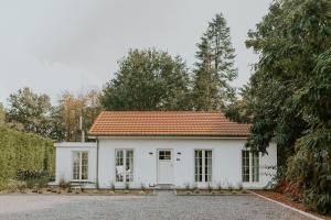 une maison blanche avec un toit rouge dans l'établissement Kipdorp39, à Brée