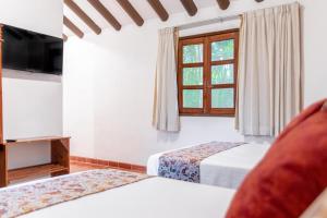 Postel nebo postele na pokoji v ubytování Hacienda San Miguel Yucatan