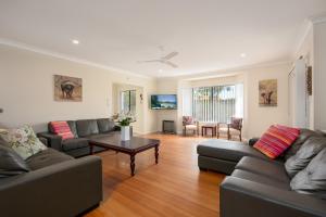 a living room with two couches and a coffee table at Oceania Peace in Yamba