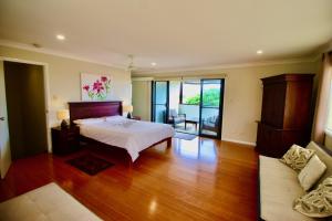 a bedroom with a bed and a couch at Oceania Peace in Yamba +18 photos