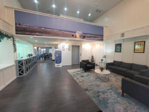 a living room with couches and a table in a building at Quality Inn & Suites Irving DFW Airport South in Irving