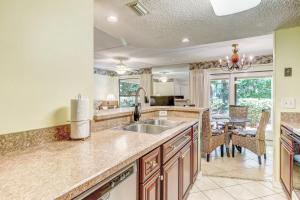 a kitchen with a sink and a dining room at Sailmaker in Fernandina Beach