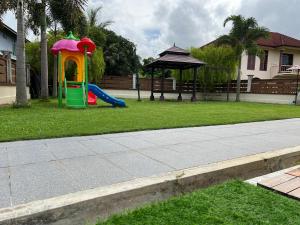 a playground in a yard with a play set at AmVilla in Kota Bharu