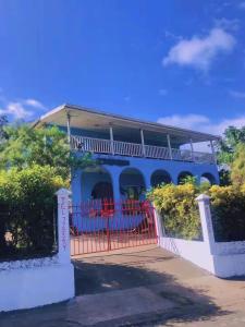 a blue house with a red gate at Room With A View & Apartment Style in Port Vila