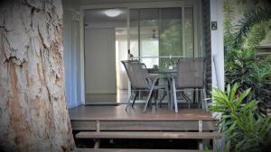 a porch with chairs and a table on a house at Dandaloo Gardens in Arcadia