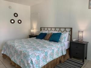 a bedroom with a large bed with blue pillows at International Inn on the Bay in Miami Beach