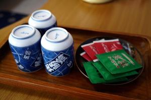 a group of three soda cans sitting on a table at Guesthouse Ichigo Ichie Nikko in Nikko