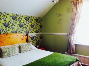 A bed or beds in a room at The Norman Guest House 