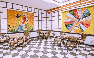 a room with tables and chairs and a mosaic wall at Rare New Marina Hotspot With Fast Free WIFI, Balcony & Pool - Western Standards - Sheraton Plaza 414 in Hurghada
