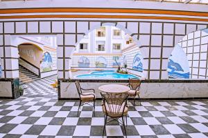 a room with a pool and a table and chairs at Rare New Marina Hotspot With Fast Free WIFI, Balcony & Pool - Western Standards - Sheraton Plaza 414 in Hurghada