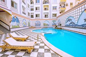 a swimming pool in the middle of a building at Rare New Marina Hotspot With Fast Free WIFI, Balcony & Pool - Western Standards - Sheraton Plaza 414 in Hurghada