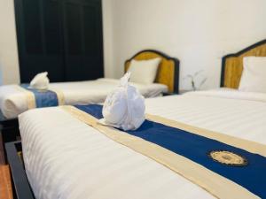 Postel nebo postele na pokoji v ubytování Angkor Tiger Resort