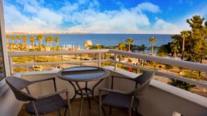 a balcony with a table and chairs and the ocean at The Corner Park Hotel in Antalya