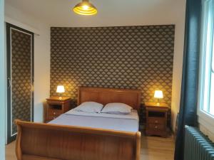 a bedroom with a bed with two night stands and two lamps at Belle dépendance, appartement cosy, tout confort in Montpellier