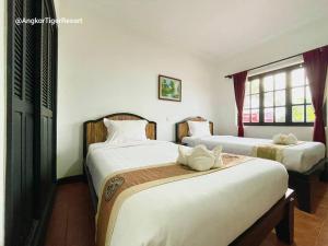 Postel nebo postele na pokoji v ubytování Angkor Tiger Resort