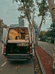 a van parked on the side of the road with its door open at Geo Campers - Full time living camper rental in Kutaisi, Tbilisi, Batumi, Georgia in Kutaisi +12 photos