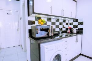 a kitchen with a washing machine on a counter at Rare 2BD Marina Hotspot With Pool, Fast Free WIFI & Balcony - 2 Kitchens & 2 Bathrooms - Western Standards - Sheraton Plaza 414-415 in Hurghada