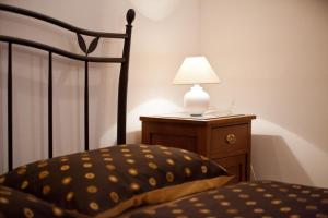 a bedroom with a bed and a lamp on a night stand at Adagio Theatre Apartment Split in Split