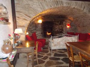 a living room with a couch and a fireplace at MAISON DE CHARME EN ARDECHE DU SUD AVEC PISCINE in Beaumont