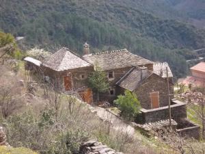 a house on the side of a mountain at MAISON DE CHARME EN ARDECHE DU SUD AVEC PISCINE in Beaumont