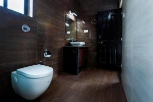 a bathroom with a toilet and a sink at Om Shanti Residence in Canacona